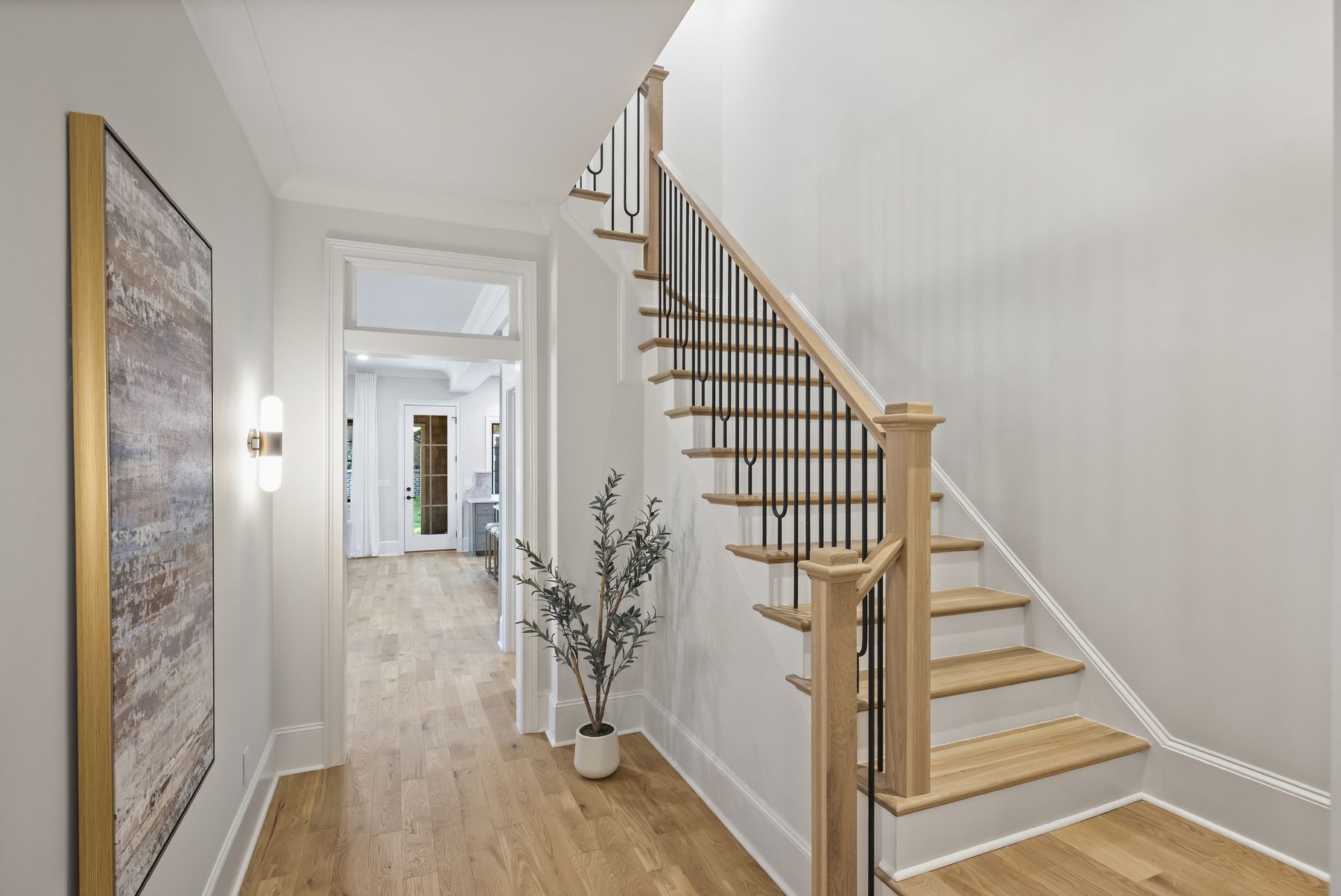 Entry foyer with a staircase and wide-plank white oak floors