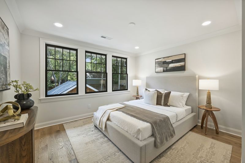 Upstairs bedroom with treetop windows