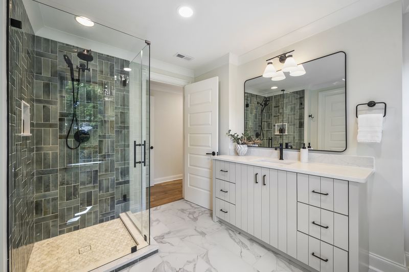 Secondary bath with green tile shower